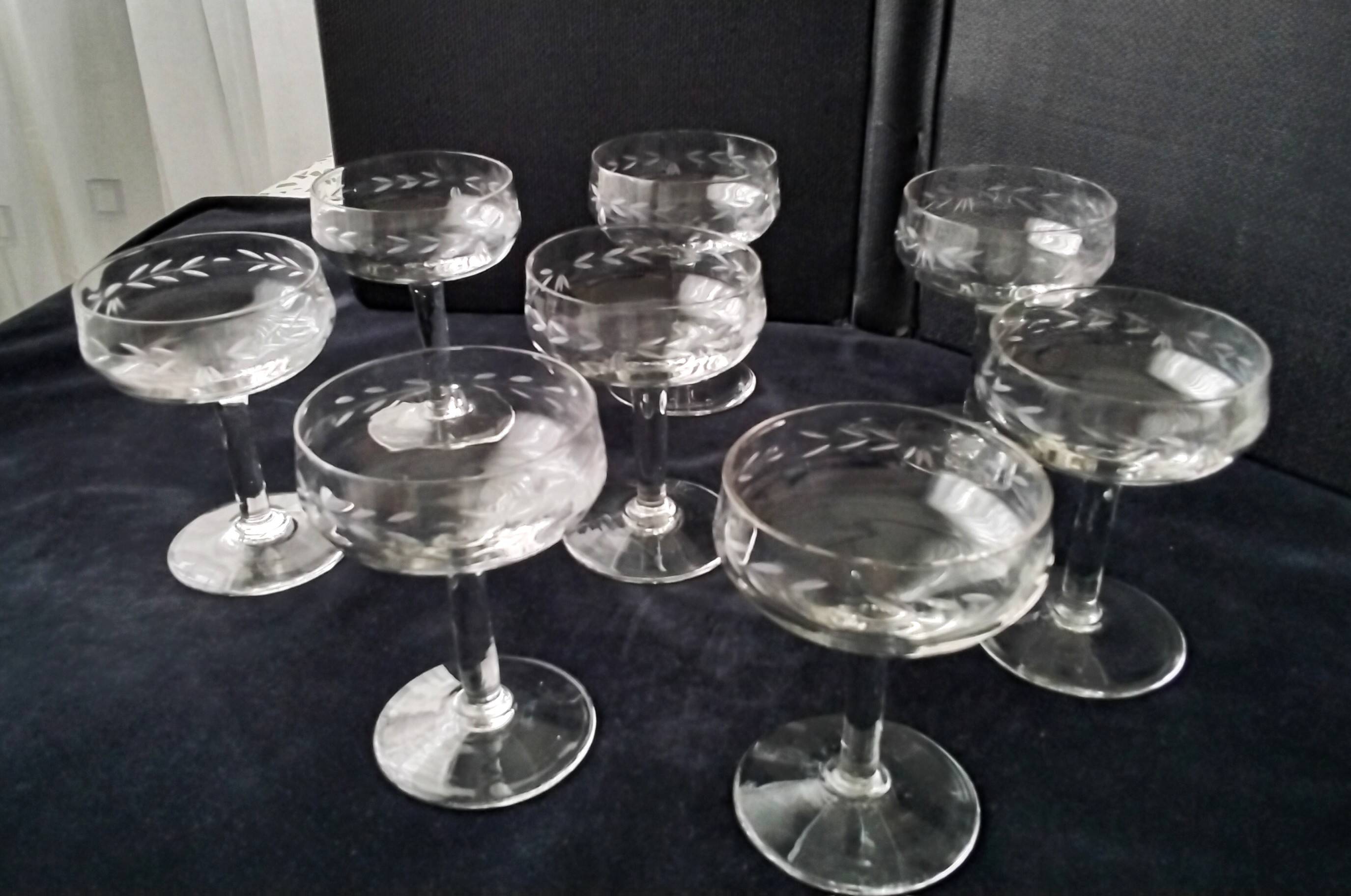 8 vintage glass champagne coupes with an engraved frieze decoration.