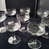 8 vintage glass champagne coupes with an engraved frieze decoration.
