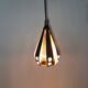 A teardrop-shaped pendant lamp made of copper, black metal, and prisms.