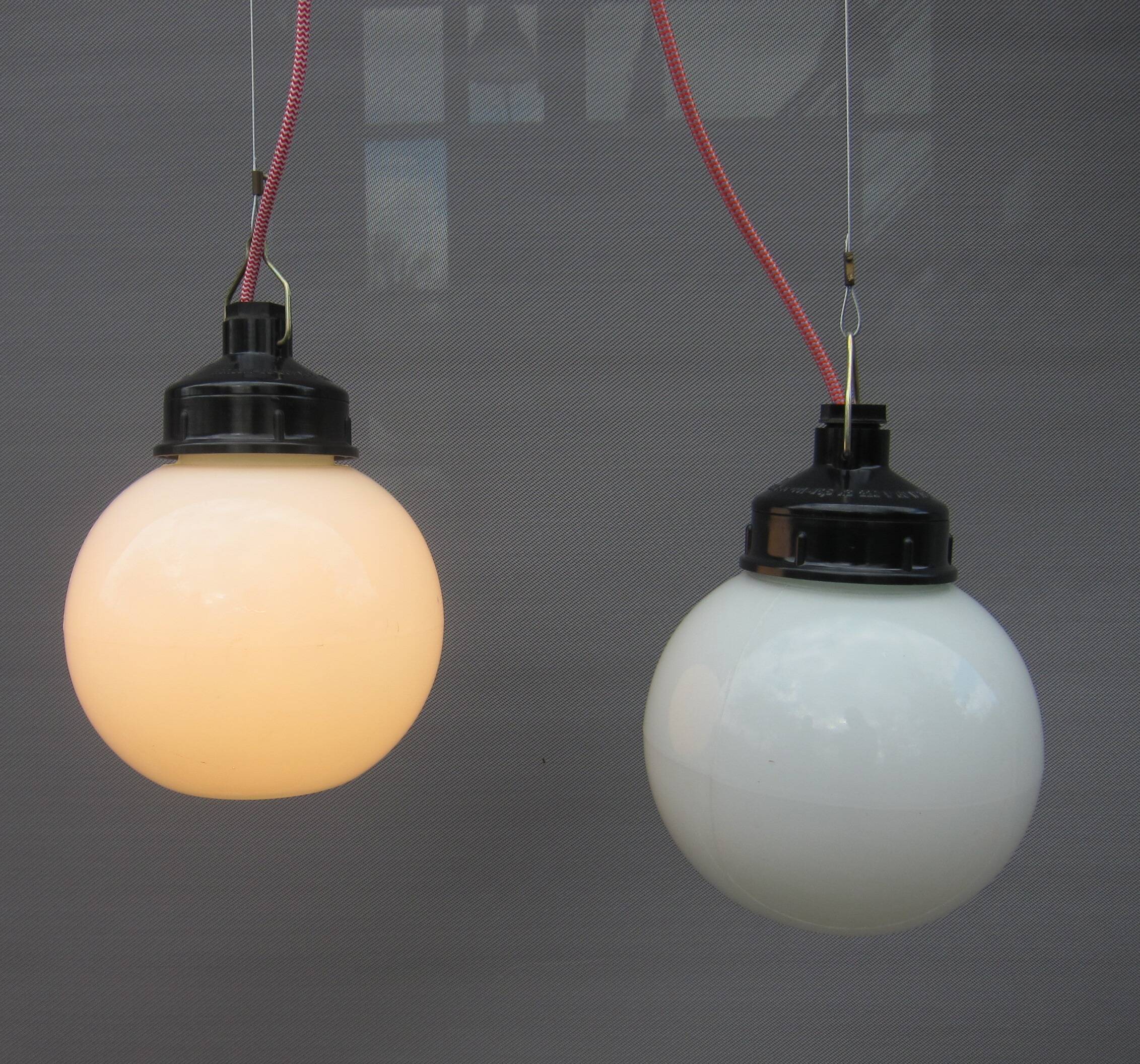 Trio of opal glass and bakelite globe pendant lights