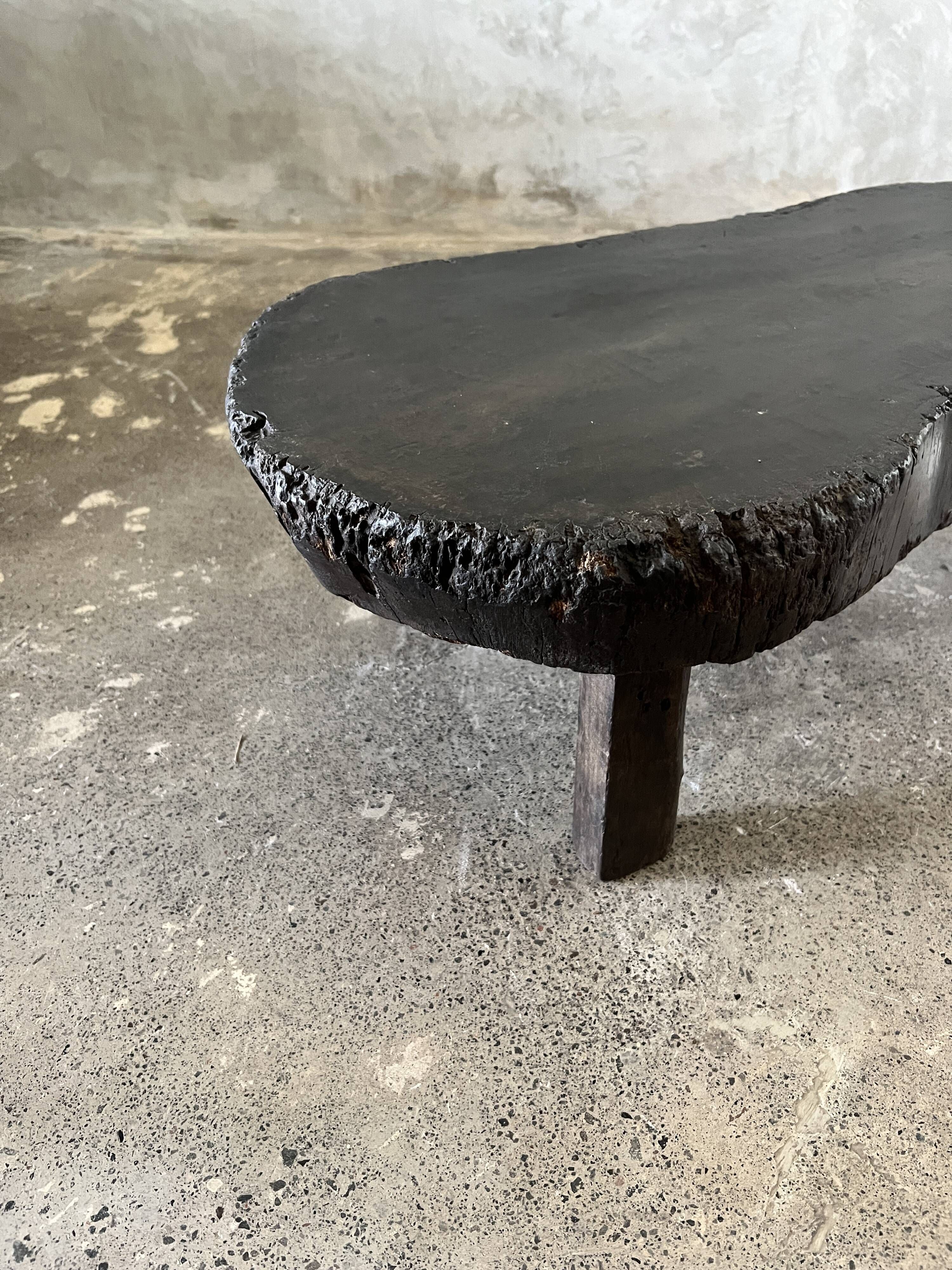 Small old Asian wooden coffee table in Japanese style, kidney-shaped top