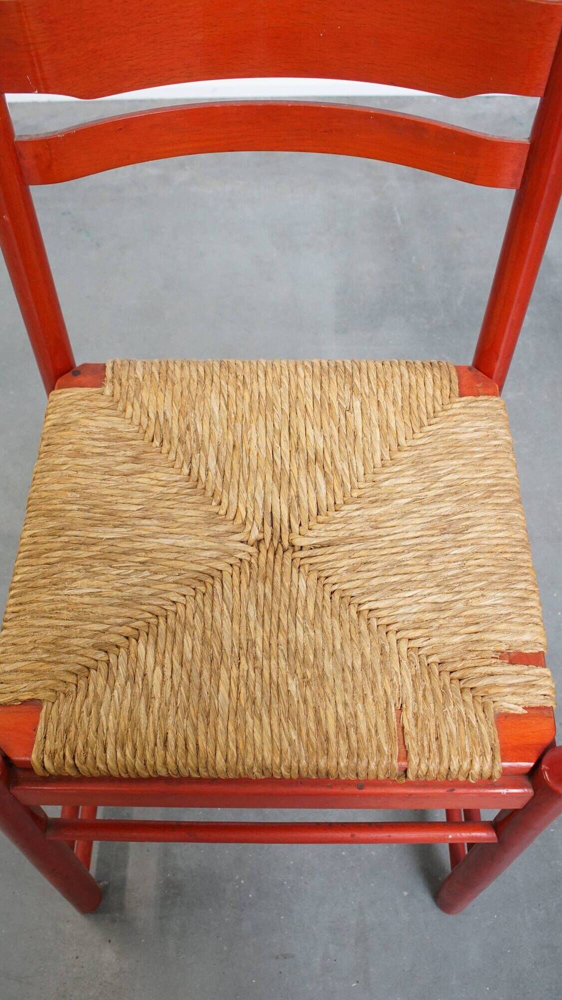 Vintage 1970s red wooden chair with a woven wicker seat