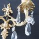 Pair of gilt bronze wall sconces with crystal pendants.