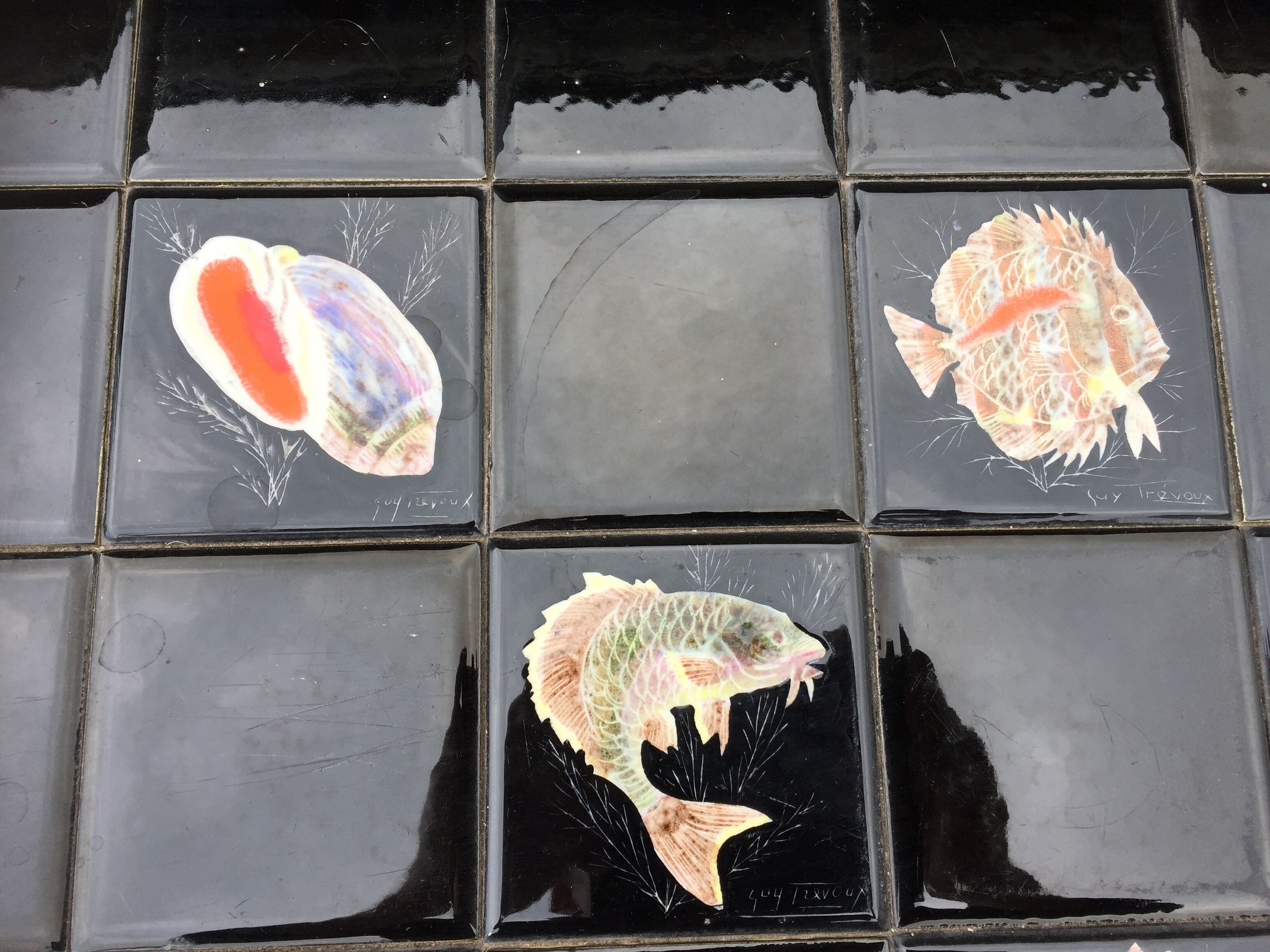 Vintage ceramic coffee table by Guy Trévoux with wrought iron base.