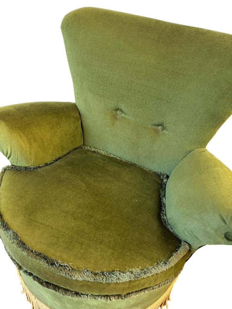 Vintage moss green cocktail chair with fringes.