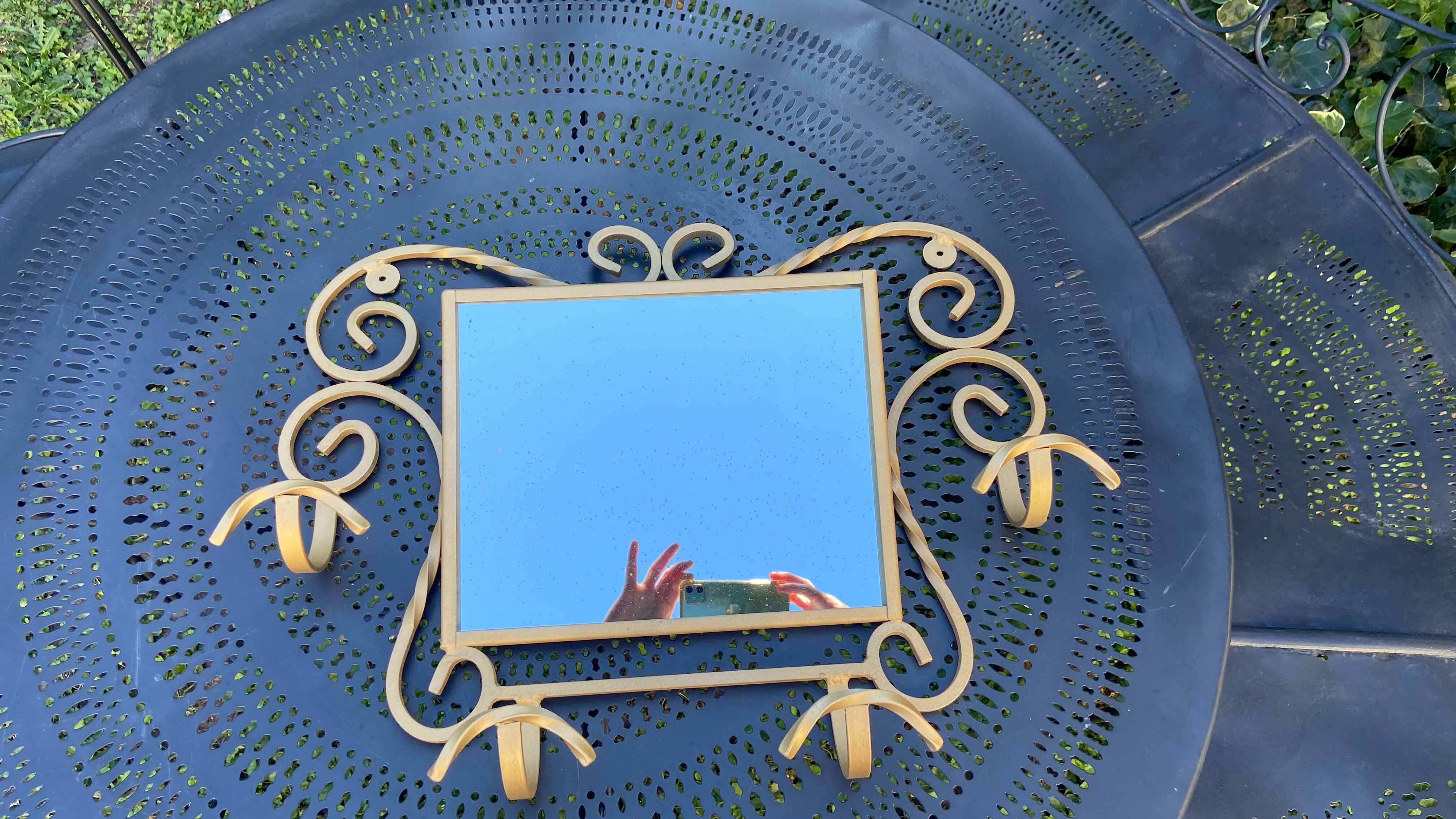 Wall-mounted gilded wrought iron coat rack with mirror