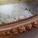 Large oval mirror with bevelled ice in stucque and wood decorated with flowers