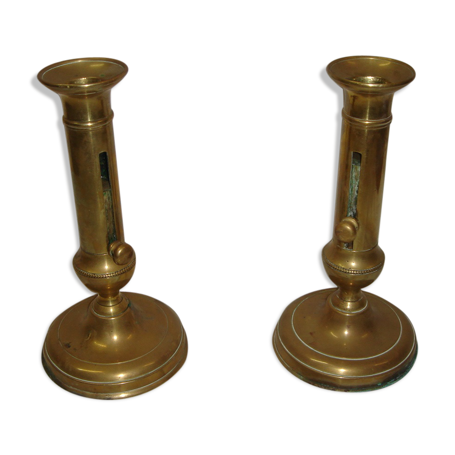 Pair of brass push-up candlesticks, 1940