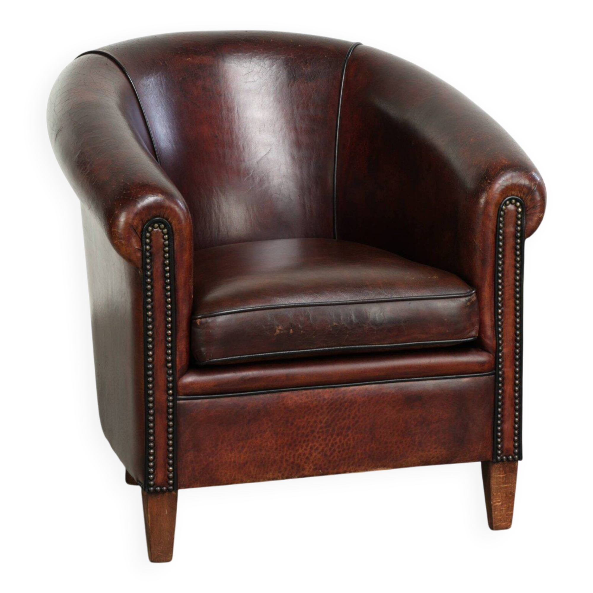Vintage sheepskin club armchair with decorative nails and black piping