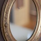 Oval wall mirror with gilded frame and mercury glass. Late 19th-early 20th century.