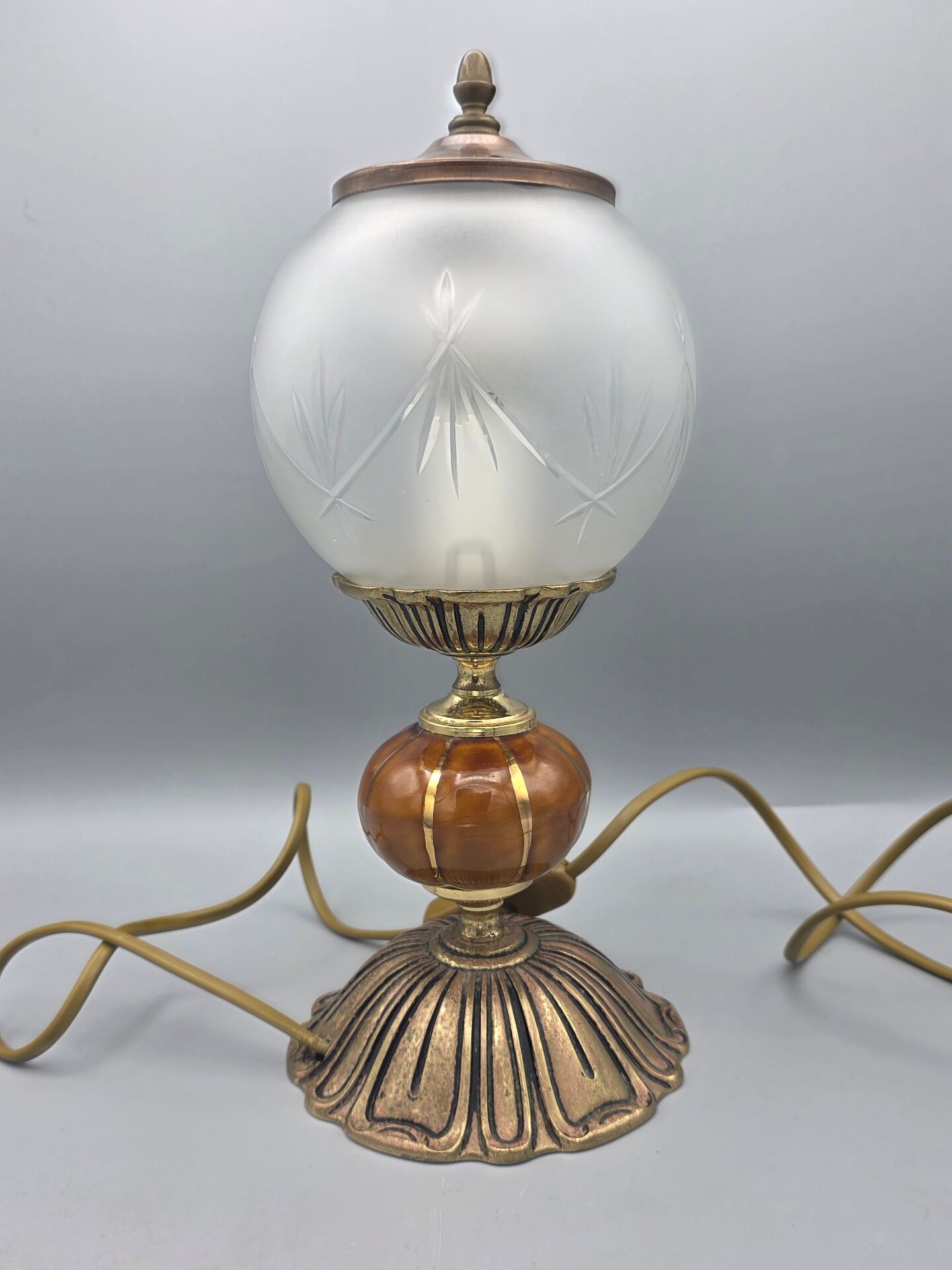 Hollywood Regency bedside lamp in gold metal with a glass globe.