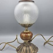 Hollywood Regency bedside lamp in gold metal with a glass globe.
