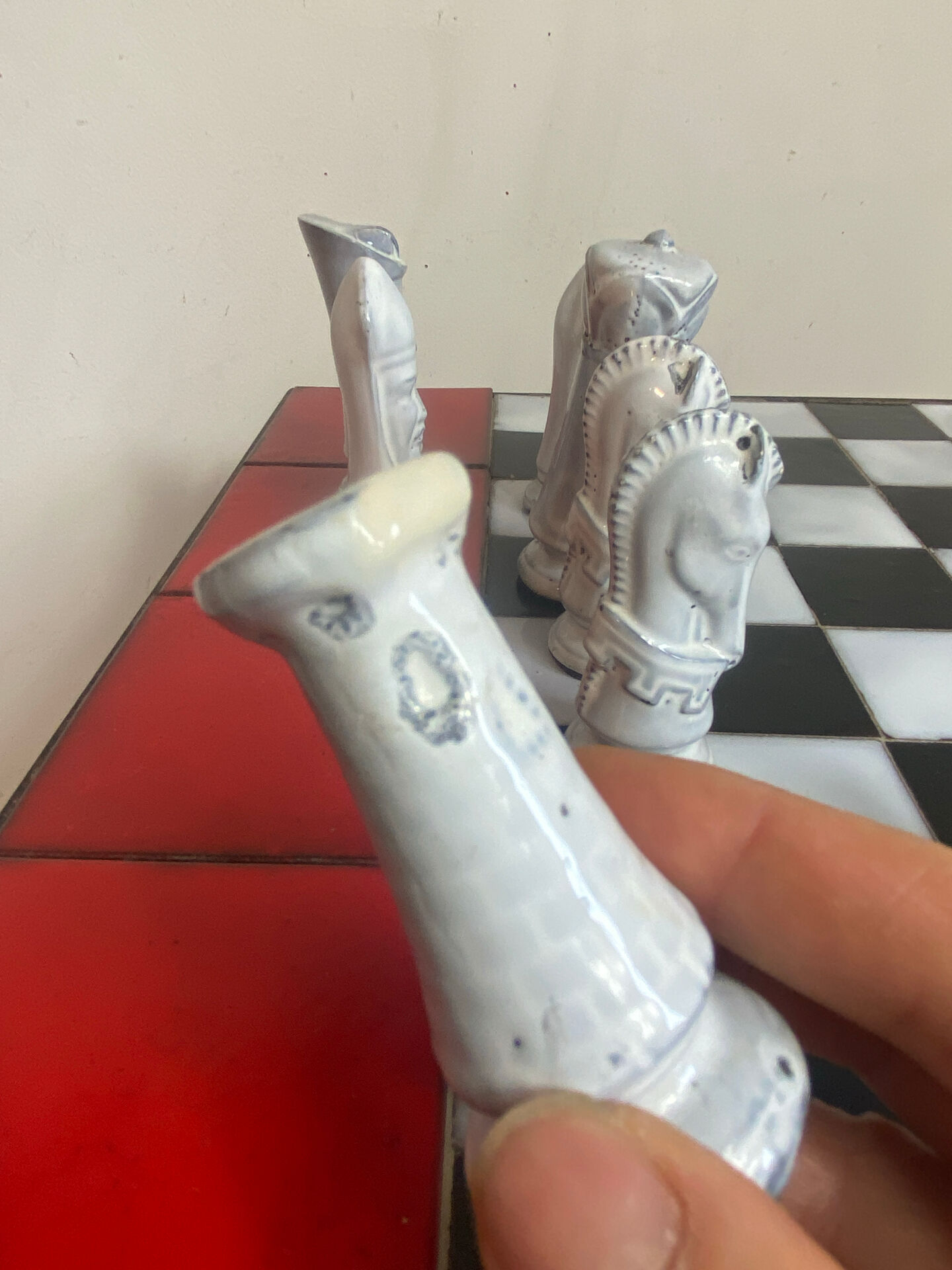 Chess set with ceramic board and pieces.