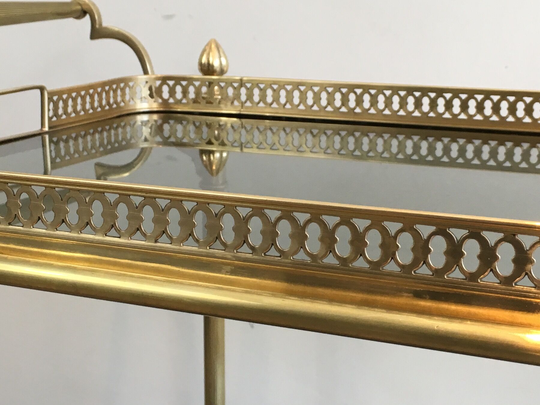 Neoclassical style rolling table in brass with blue glass tops