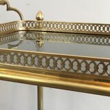 Neoclassical style rolling table in brass with blue glass tops