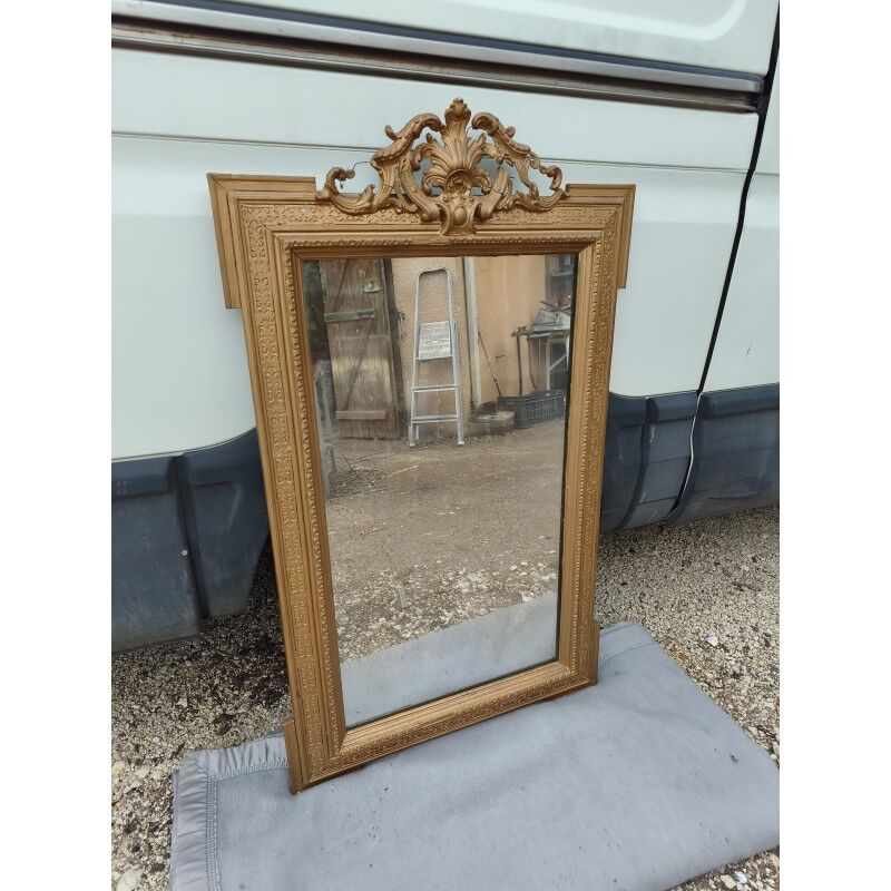 19th-century mirror in gilded wood and stucco.