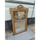 19th-century mirror in gilded wood and stucco.