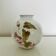 Round vase with floral decoration, signed.