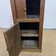 Old small storage unit with sliding and hinged doors.