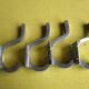 Set of four aluminium coat hooks from the 1950s.