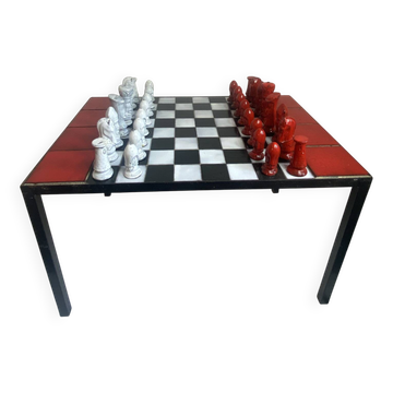 Chess set with ceramic board and pieces.