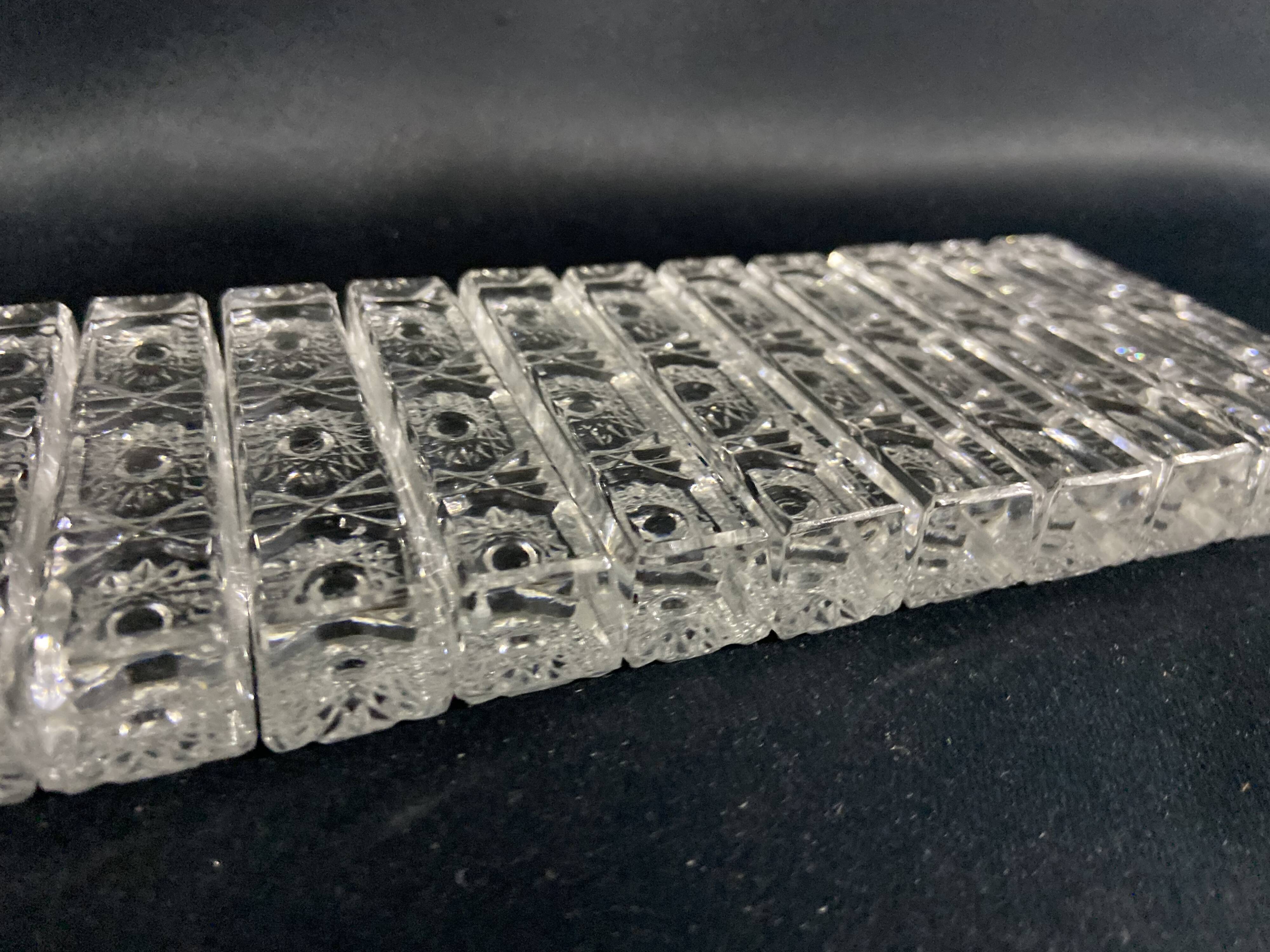 Set of 12 molded glass or crystal knife rests with diamond point decor