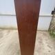 Oak two-column filing cabinet with curtains.