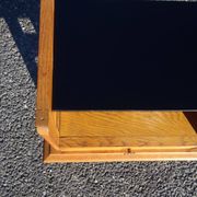 Vintage oak bedside table with tapered legs.