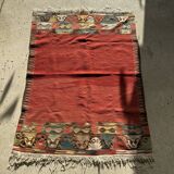 Small wool rug, predominantly red with geometric patterns