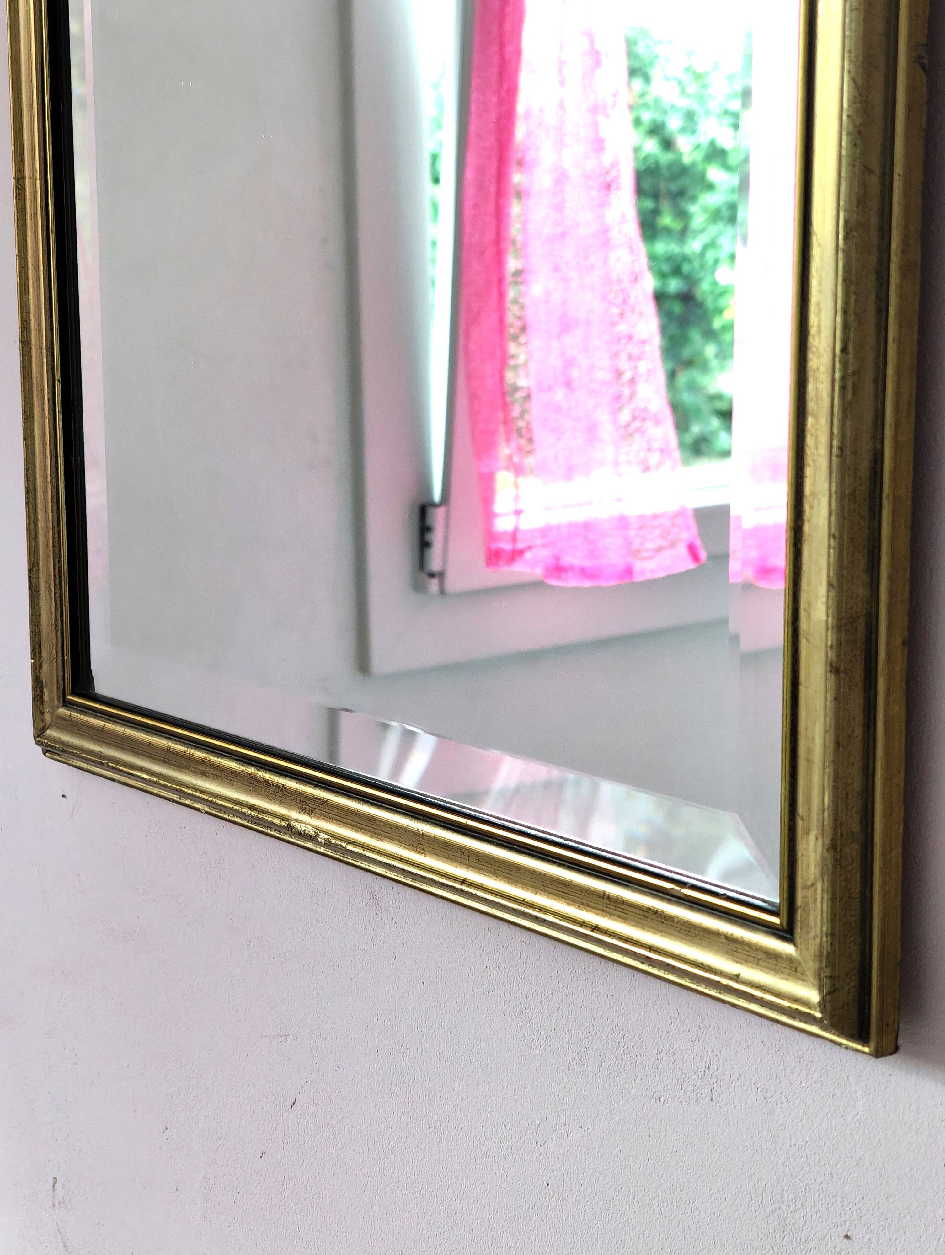 Rectangular gold mirror with bevelled glass.