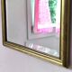 Rectangular gold mirror with bevelled glass.