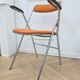 6 orange folding chairs