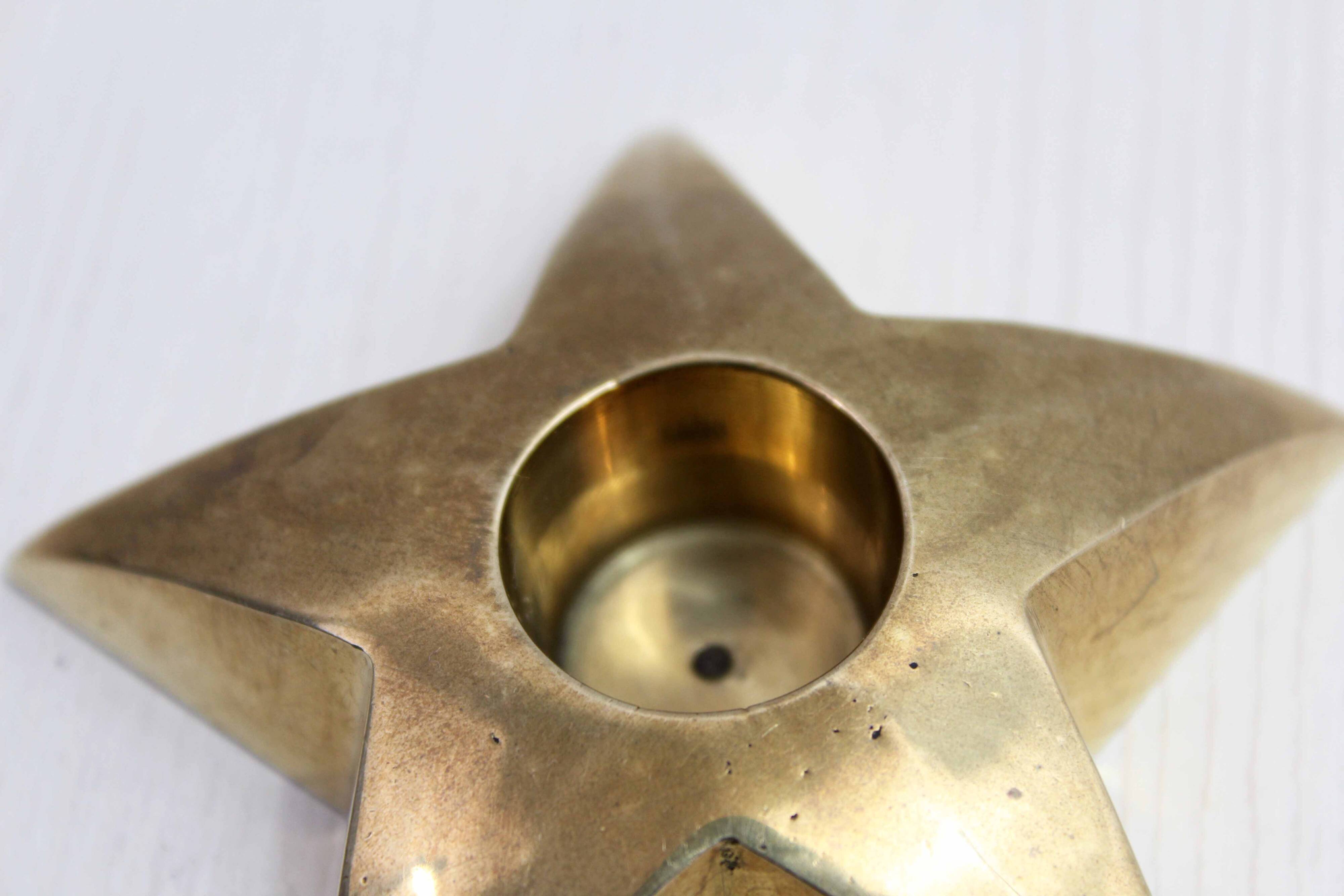 Star-shaped brass candle holder