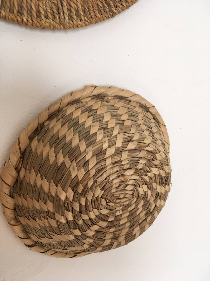 Wall composition of seven baskets and wicker trays