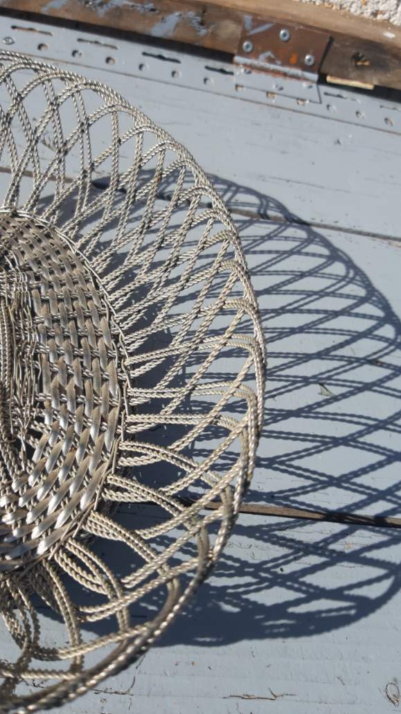 flat basket cut center table in woven metal