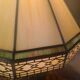 brass and bronze lamp with an antique base from 1900 and a glass paste shade