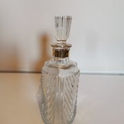 Cut glass carafe with a gold band on the neck.