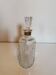 Cut glass carafe with a gold band on the neck.
