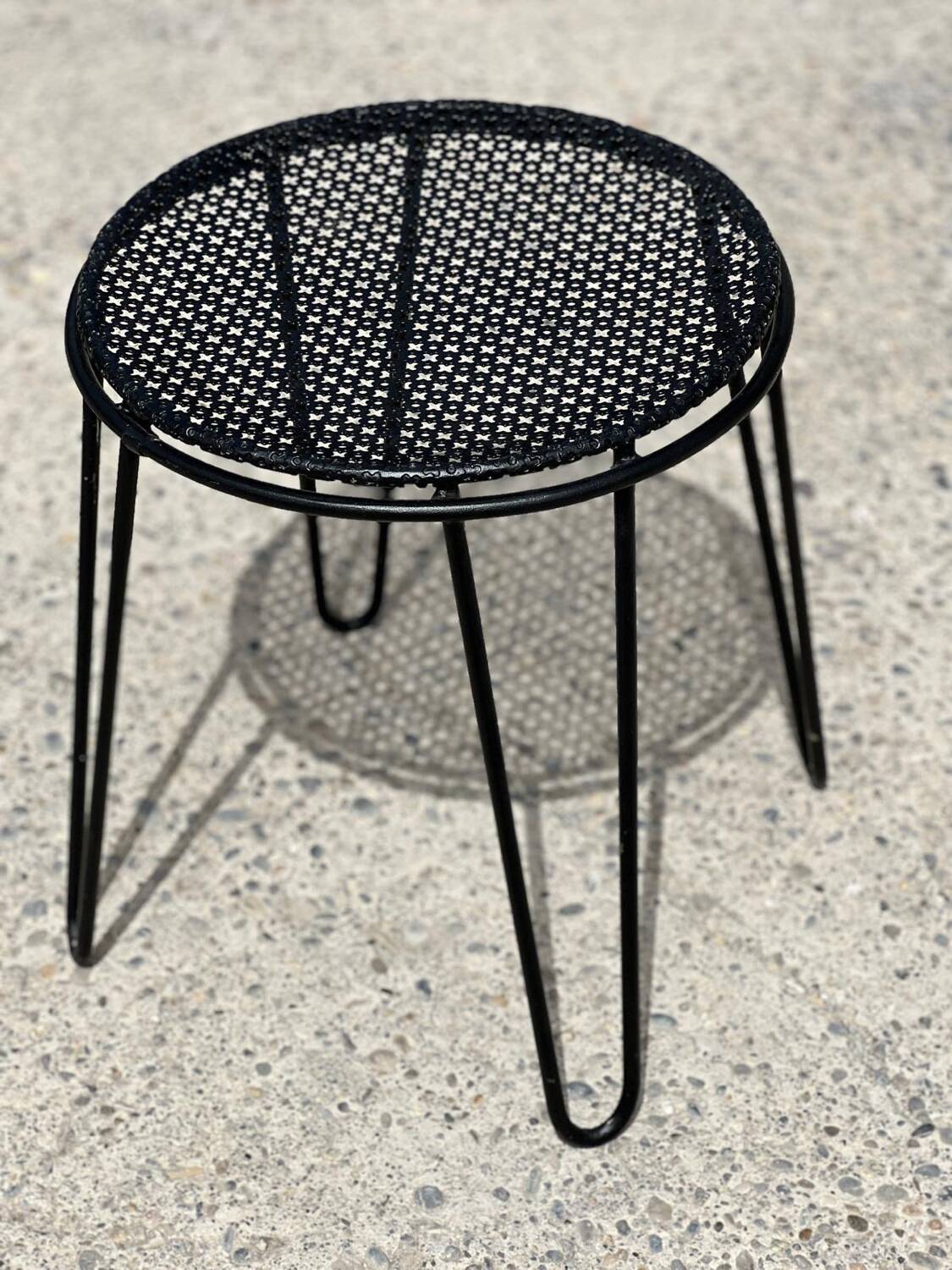 Perforated metal stool