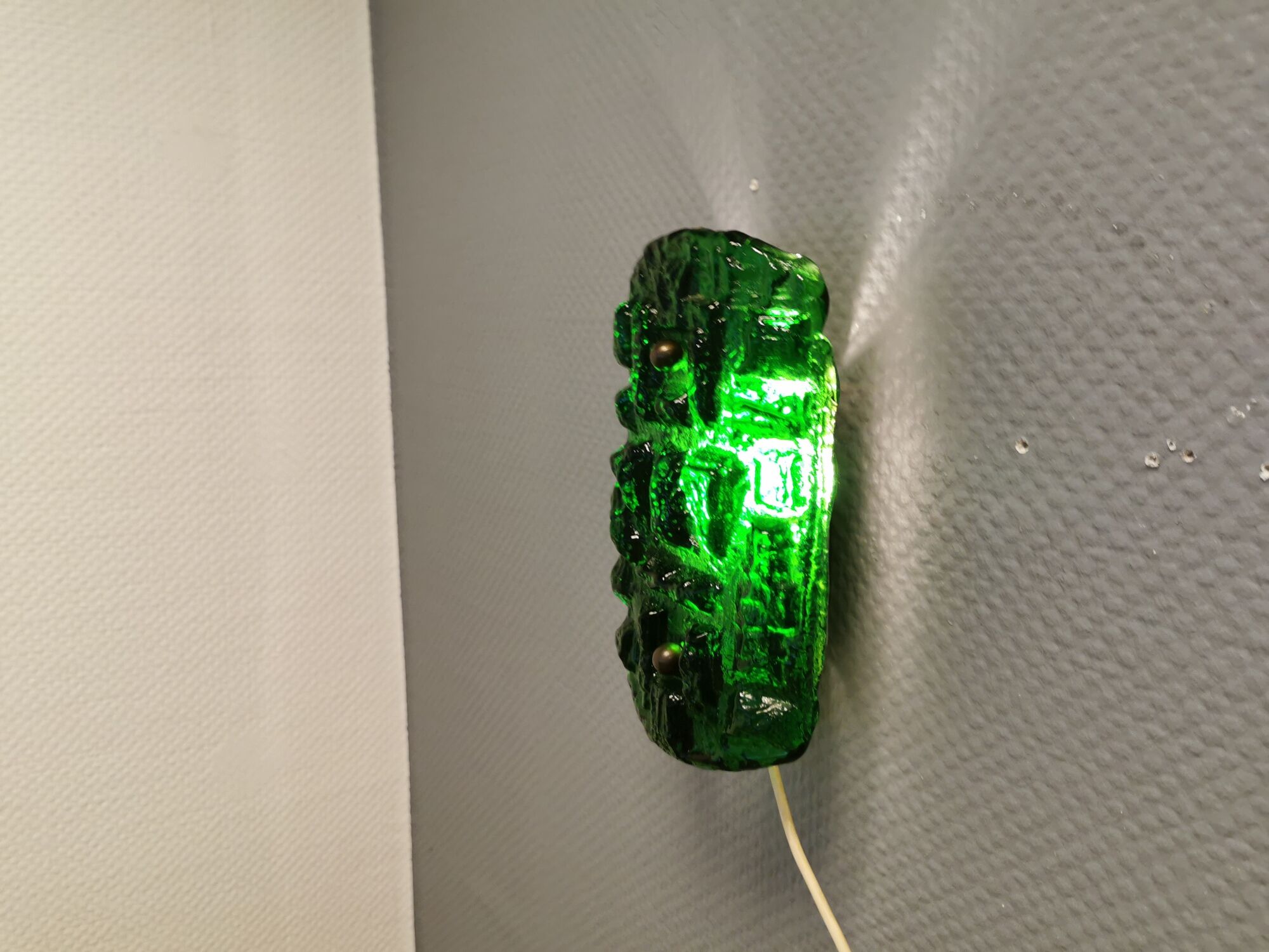 Old wall lamp made of hard pressed green glass.
