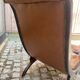 Chesterfield armchair in leather and carved solid wood