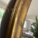 Miroir en bois doré patiné 58cm