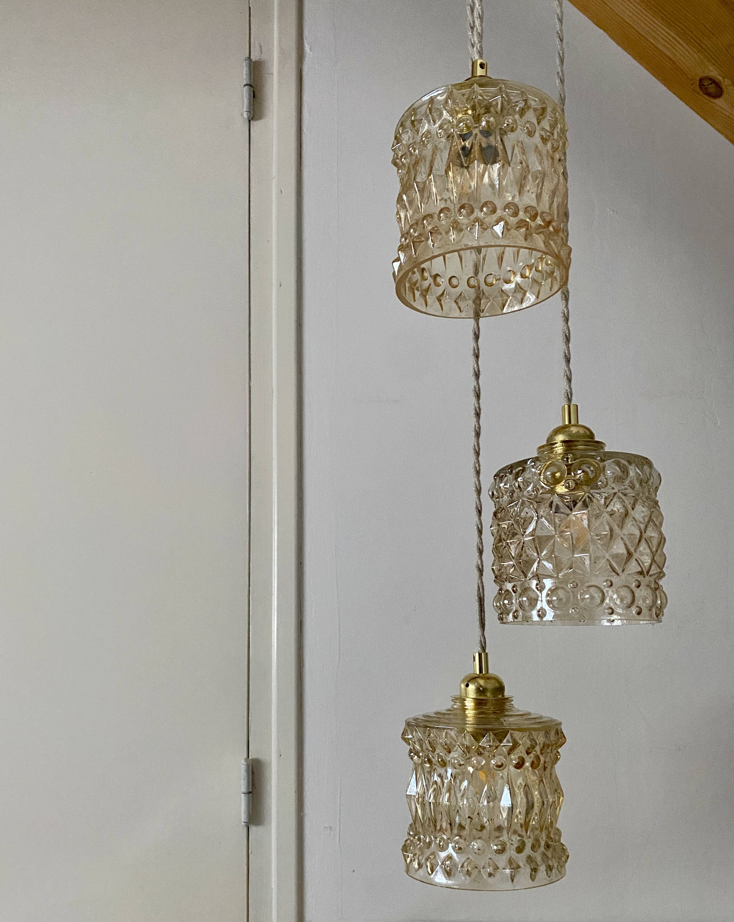 Triple antique globe pendant light in amber glass