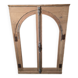 Old arched window made of fir wood