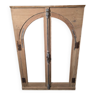 Old arched window made of fir wood