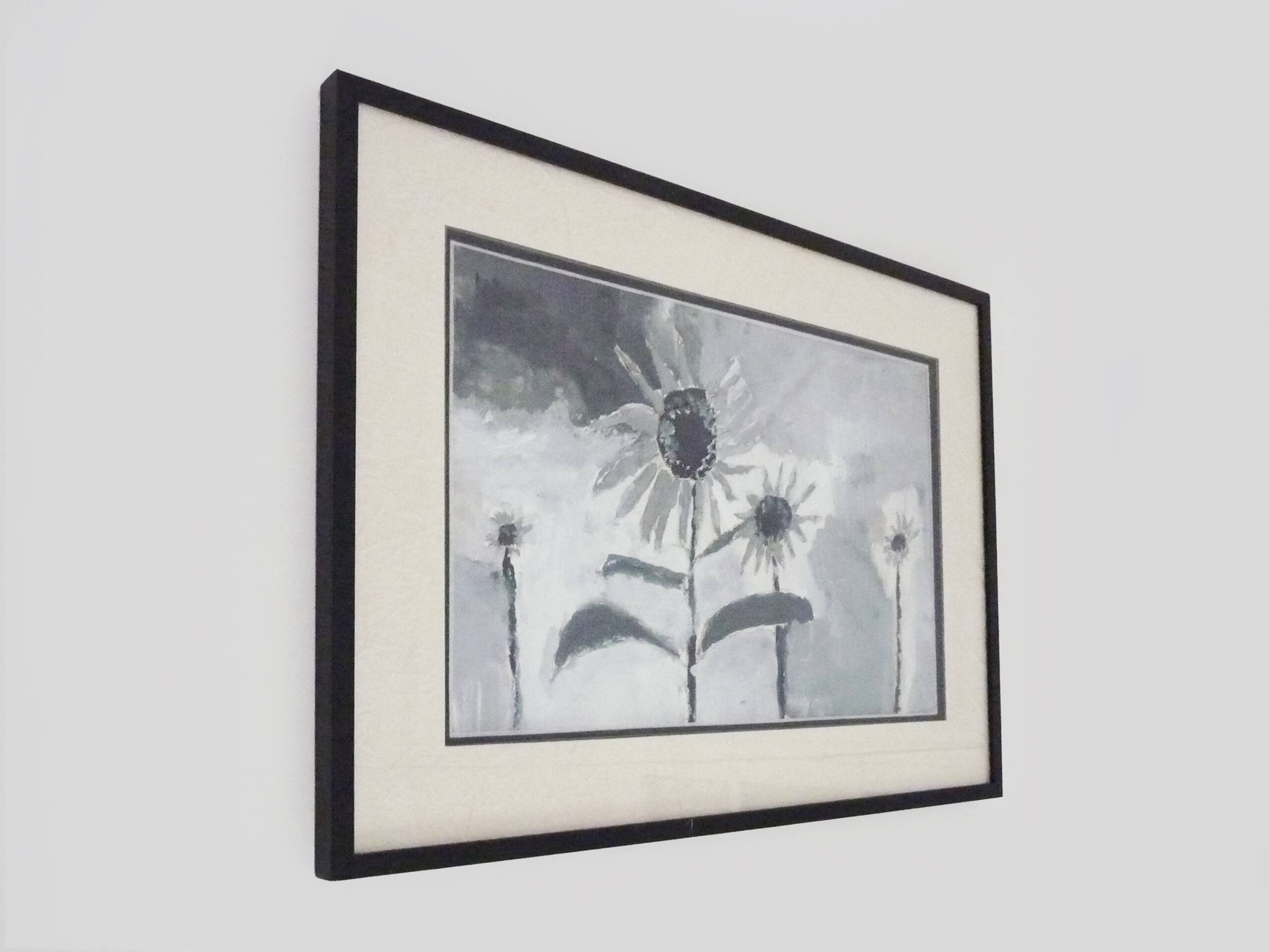 Framed painting with gray flower decor.