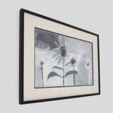 Framed painting with gray flower decor.
