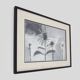 Framed painting with gray flower decor.