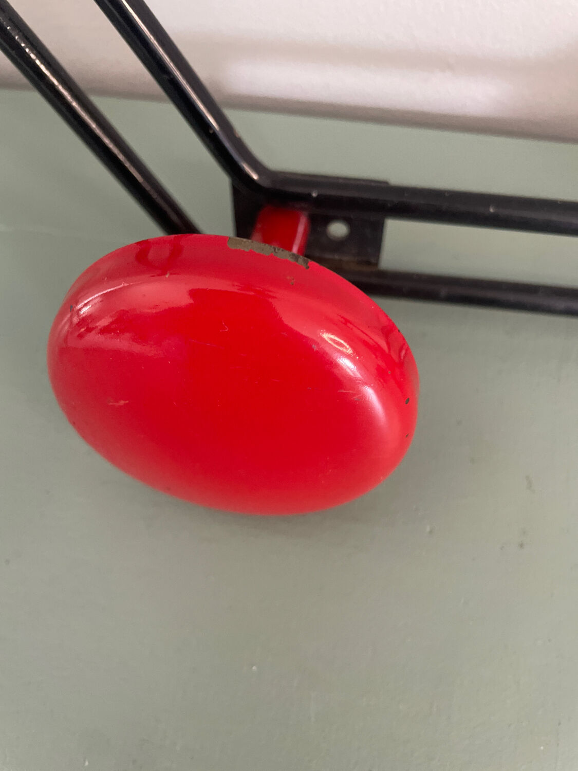 Coat rack, red and black metal hook.