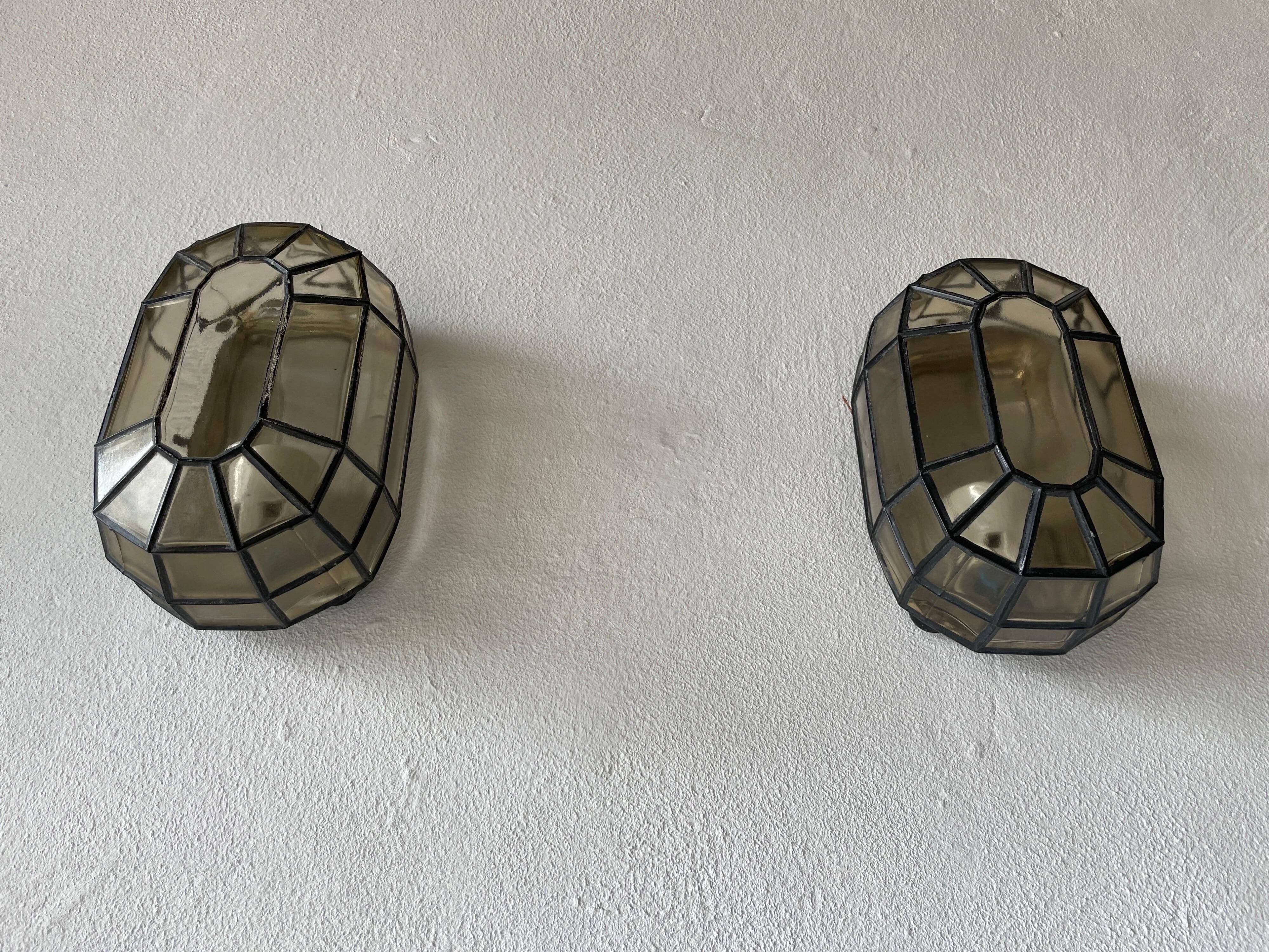 Pair of black iron wall sconces with structured glass by Limburg, 1960s, Germany.